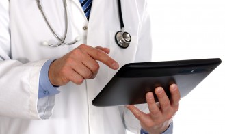 bigstock-doctor-using-a-digital-tablet-31270601-329x196