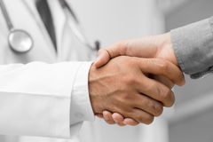 doctor-shakes-hands-patient-hospital-64054443